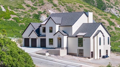 View of front of house with driveway, stucco siding, roof with shingles, a garage, and central AC unit