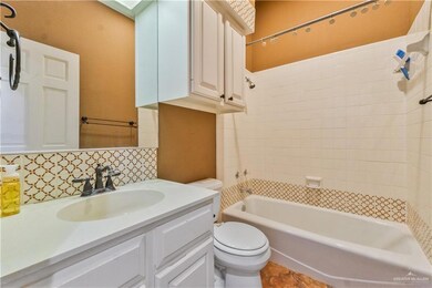Bathroom with tasteful backsplash, vanity, and shower / bathtub combination