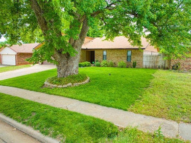 View of front facade with concrete driveway, brick