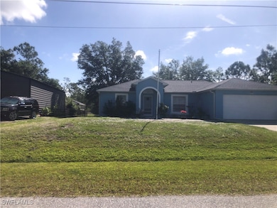 Single story home with a front yard, an attached g