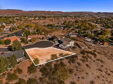 Aerial overview of property's location featuring a mountain backdrop, property boundaries highlighted, and nearby suburban area
