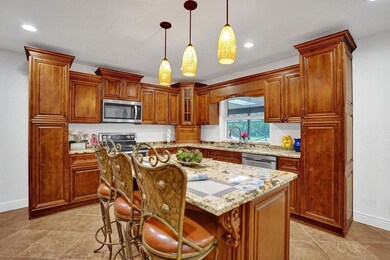 Updated kitchen with wood cabinets, granite counte