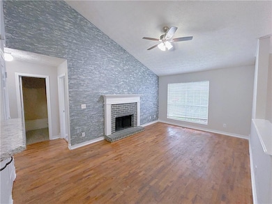 Unfurnished living room featuring baseboards, ceil