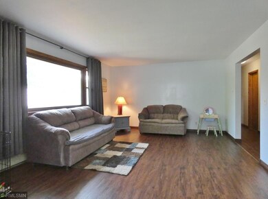 Spacious living room is filled with abundant natur