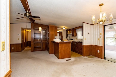 Kitchen with wood walls, a wainscoted wall, and ce