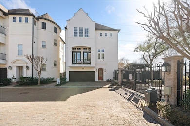 View of front facade with decorative driveway, stu