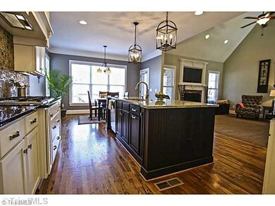 Kitchen. Stainless appliances include side by side refrigerator with drawer. Built in Bosch convection oven, microwave and 6 burner stove top. Breakfast Bar that seats 4.  Accent Lighting. Single oversized sink. 2