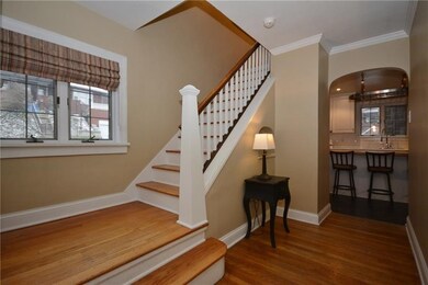 Entry hallway. Powder room on the landing to the l
