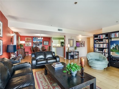 Living room with visible vents, wood finished flo