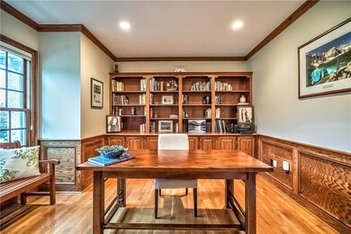 The sizable, handsome study features wainscoting a
