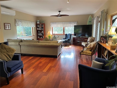 Library & family room off entry foyer with mini ba