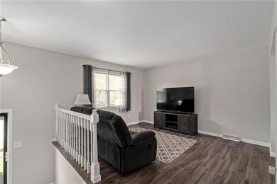 Living room with dark wood-type flooring