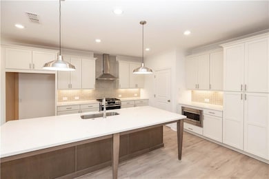 Stainless appliances include gas stove, venthood, dishwasher and built in microwave.  Pictures represent a previously built home, not the actual home.
