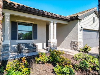 View of exterior entry with a garage