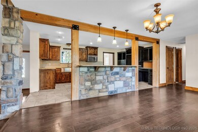 Kitchen with stainless steel microwave, a chandeli