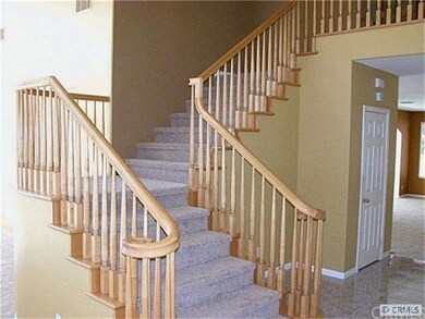 Custom wood stairway to bedrooms and bonus room