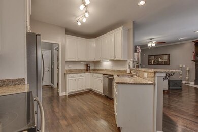 This fantastic kitchen has granite, hardwood and o