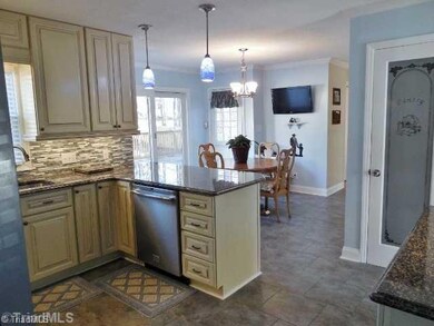 Breakfast. The breakfast area has a terrific view of the back of the home.  The custom, glass pantry door adds a designer touch to the kitchen.