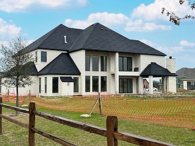 Back of house featuring a yard