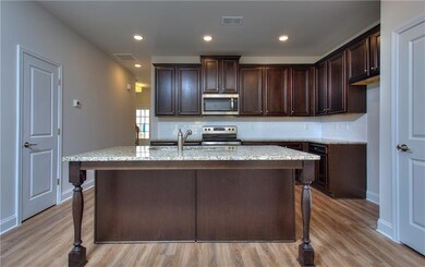 Kitchen with backsplash, stainless steel appliance