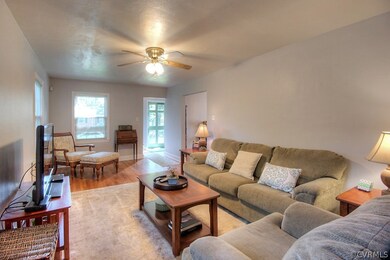 The living room has hardwood flooring, fan/fixture