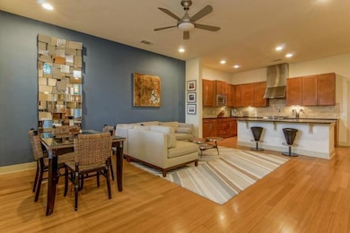 Dining space featuring a ceiling fan, light wood-