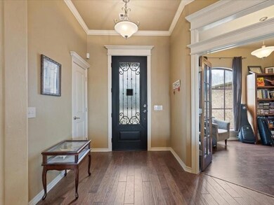 Entryway with crown molding and dark hardwood / wo