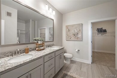 Bathroom featuring vanity, toilet, tile patterned
