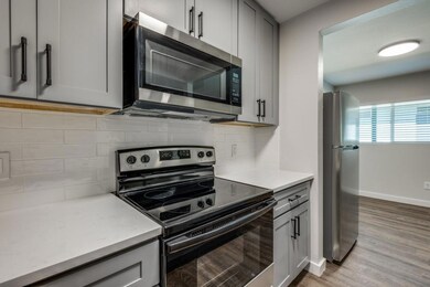 Kitchen with decorative backsplash, appliances wit