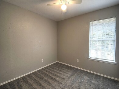 Bedroom 1 with ceiling fan and fresh new carpet