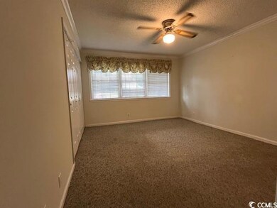 Carpeted main bedroom (11 x 14) featuring crown mo