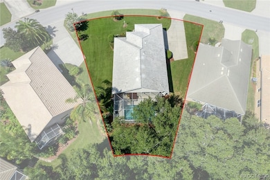 Aerial view of this oversized lot with mature tree