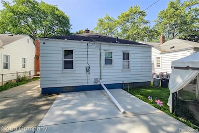 Rear view of house with a patio and a chimney