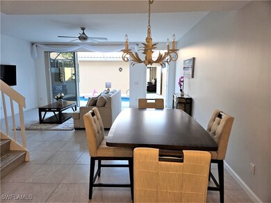 Dining space with ceiling fan with notable chandel