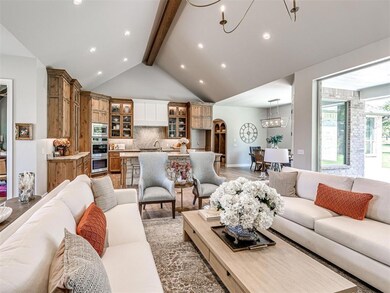 Living room with an inviting chandelier, high vaul