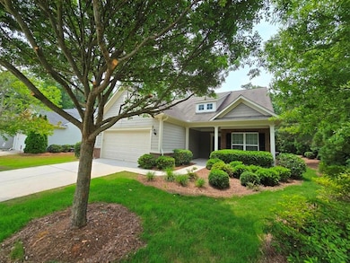 View of front of home with brick siding, driveway, and a front yard