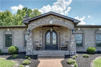 Grand entrance with imported iron front doors.