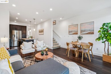 Living area with dark wood finished floors, recessed lighting, and stairs