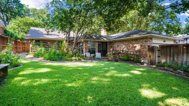 Back of property with a lawn