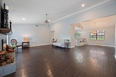 Living area featuring a fireplace, ceiling fan, a