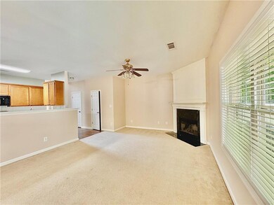 Unfurnished living room featuring carpet floors, a fireplace, and ceiling fan