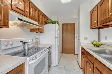 Galley kitchen with door to laundry/pantry.