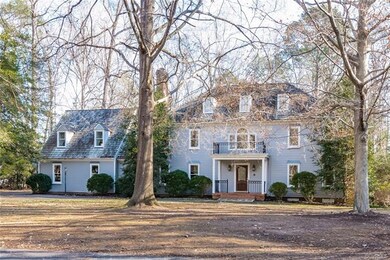 Mature hardwoods frame the home