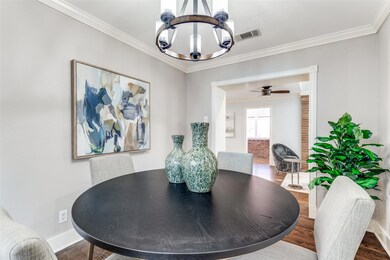 Dining room with wood floors, baseboards, an invit