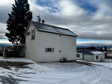 Back of house with carport