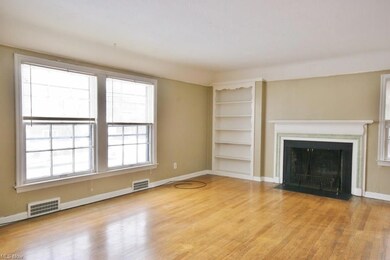 Spacious living room with fireplace and hardwood f