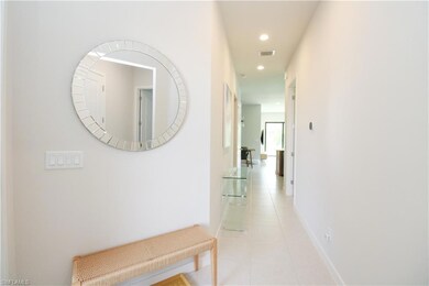 Corridor with light tile patterned flooring