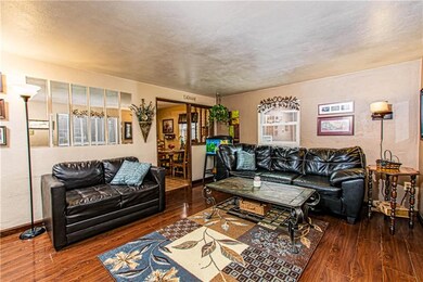Well appointed living room with wood laminate floo