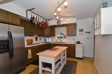 Island adds additional storage and work space.  Ne