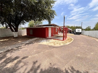View of outdoor structure featuring driveway